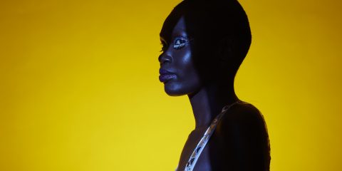 Optical Spot by Lindsay Adler with a blue/violet gel on key light and a yellow/orange gel on the backlight