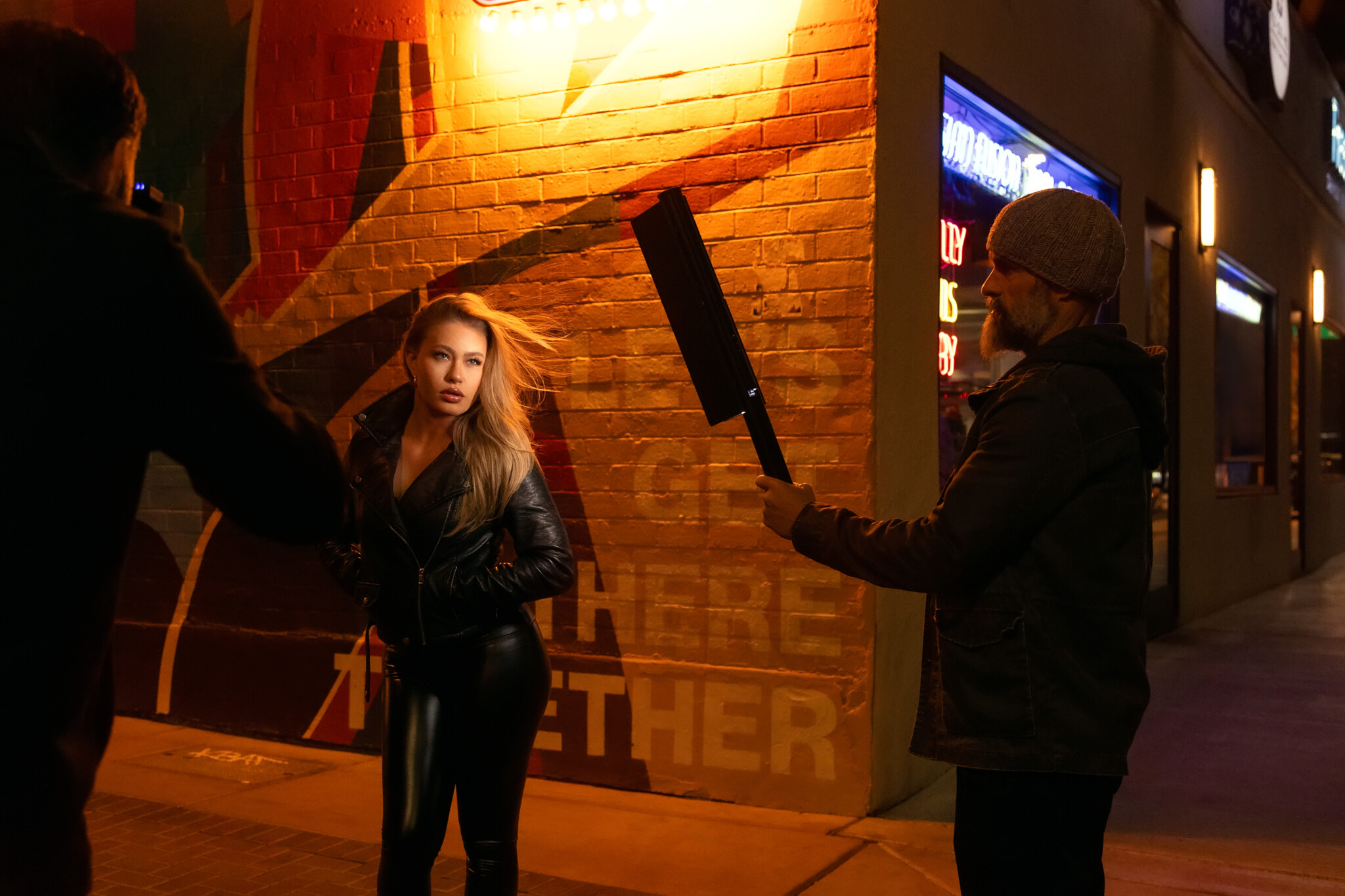 Behind the scene of a woman with blond hair flowing in the wind
