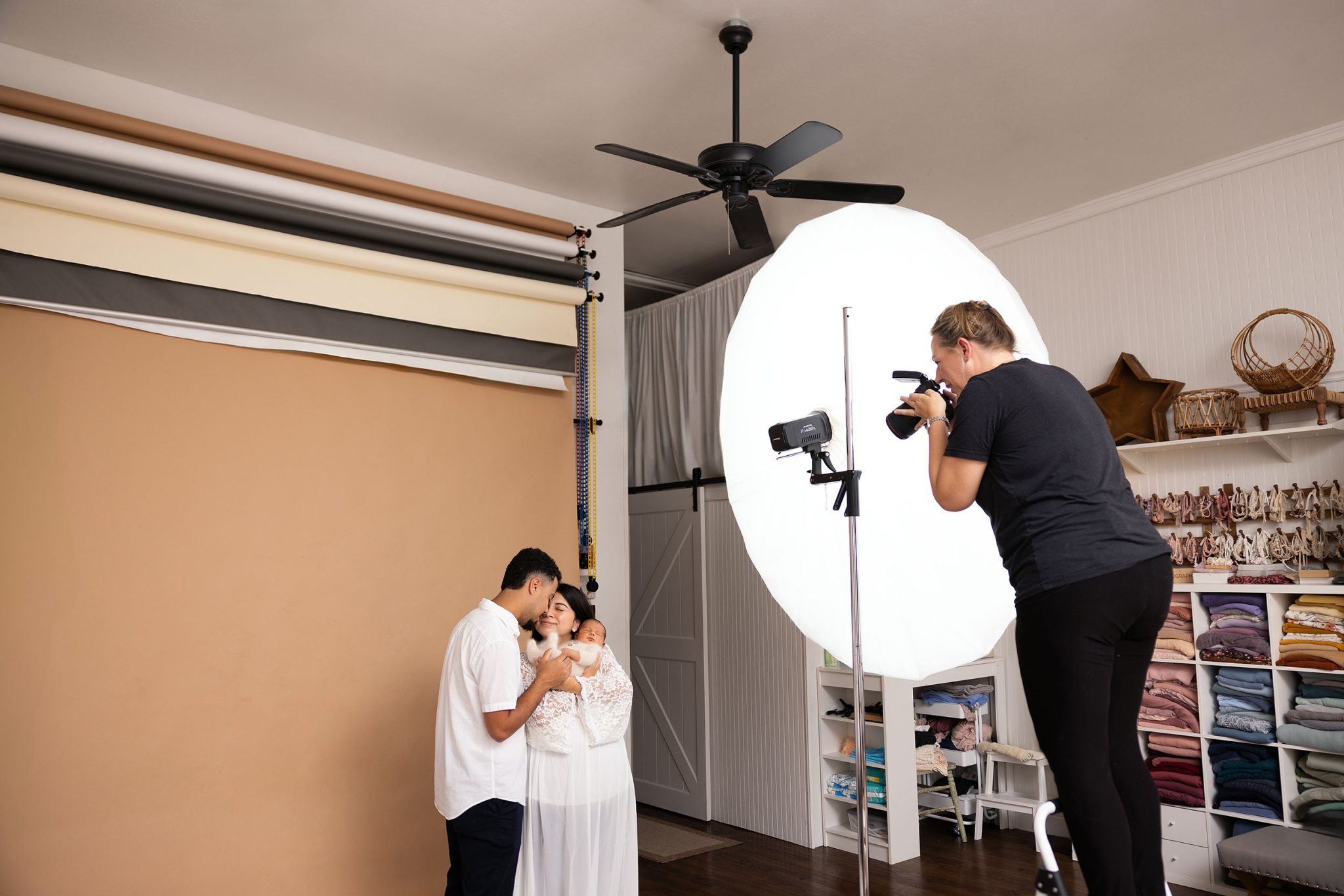 Behind the scenes showing one-light family portrait setup using the FJ400 II and 7-ft umbrella.