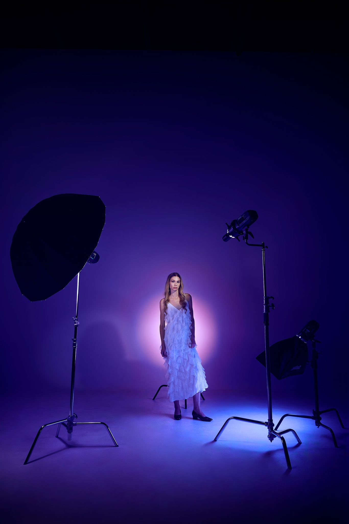 Behind the scenes look at a soft gel setup with blue purple and pink FlexiGels for analogous color portraits BTS of model shot with multiple gelled colors