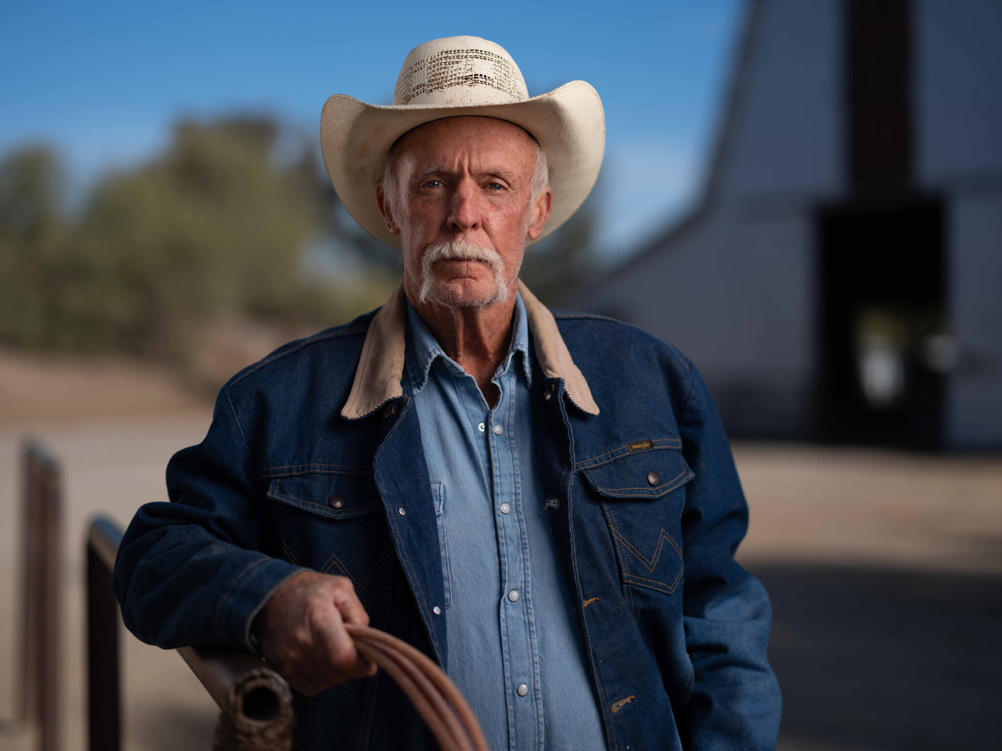 Portrait with a shallow depth of field Older man wear a cowboy hat and holding a lasso