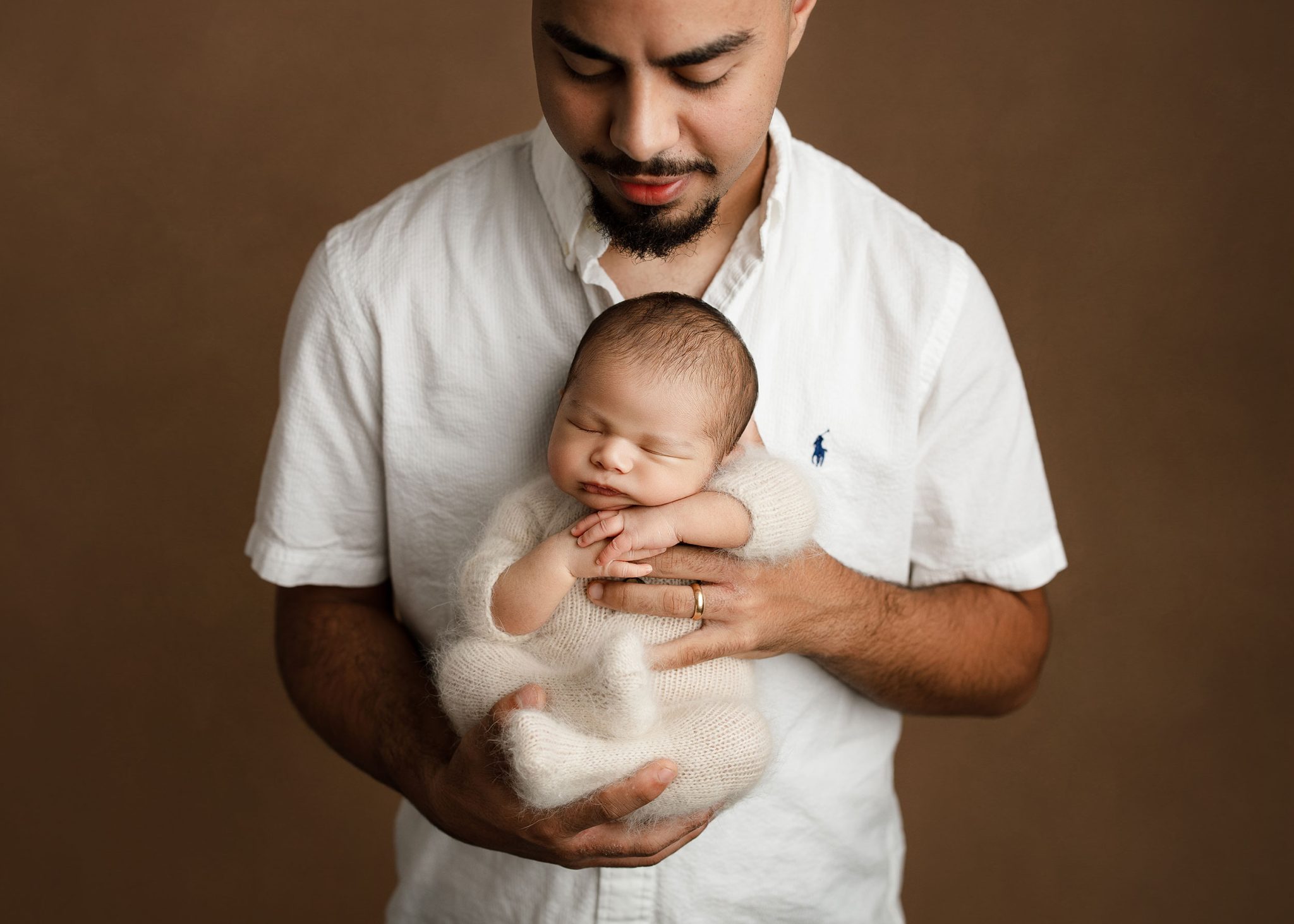 Dad and baby portrait lit with one FJ400 II and 7-ft umbrella for clean, soft light.