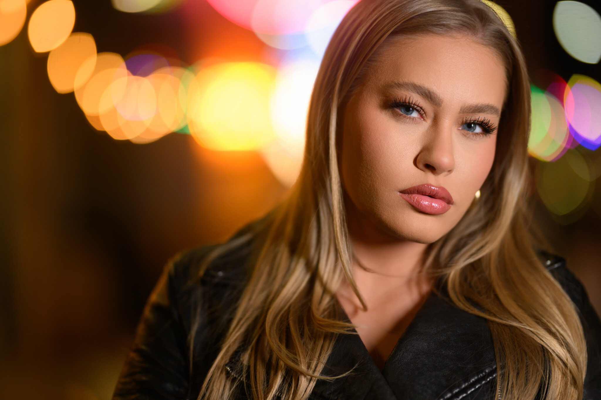 Close up of a woman with blonde hair in a black jacket
