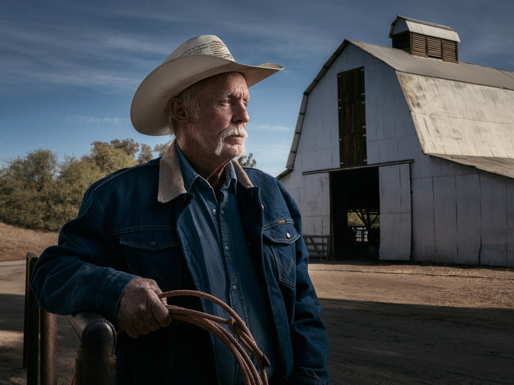 Outdoor portrait of Larry Simpson lit with two FJ800 strobes Older man wearing a cowboy hat looking off into the distance
