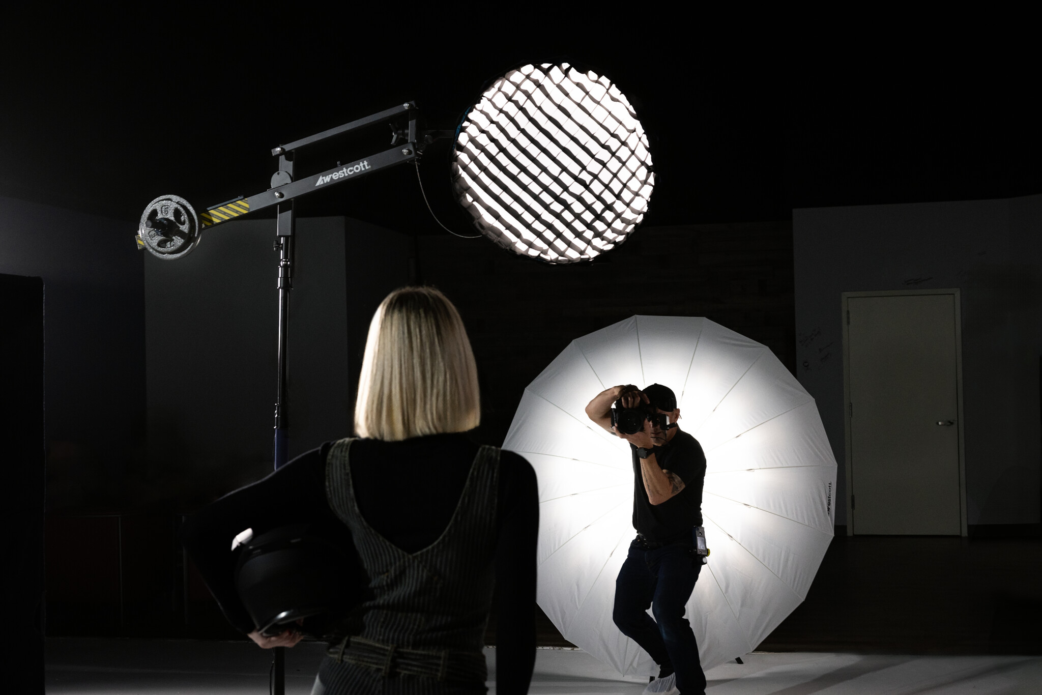 Behind the scenes of a photographer shooting a blonde model