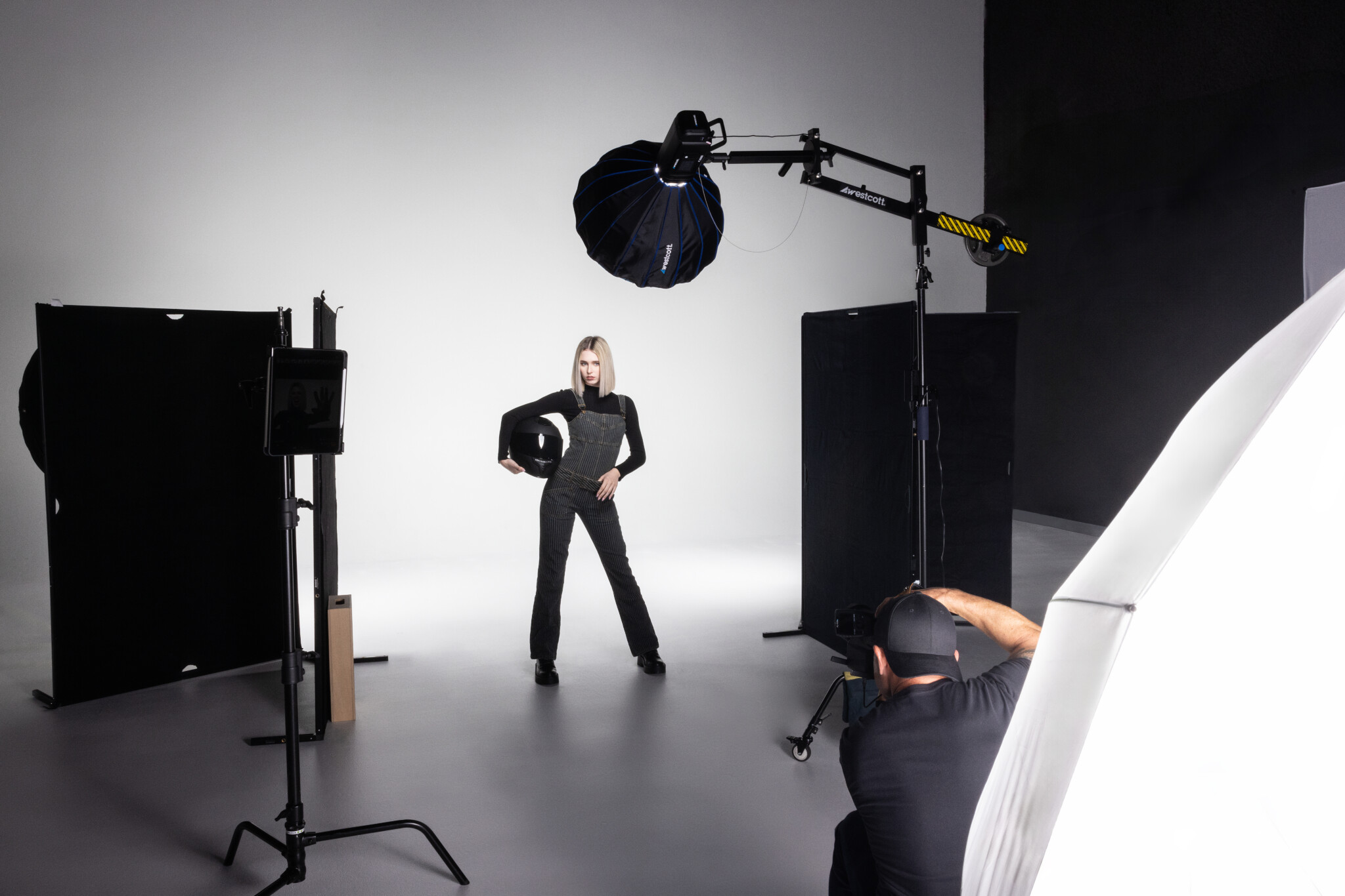 Behind the scenes of a photographer shooting a blonde model