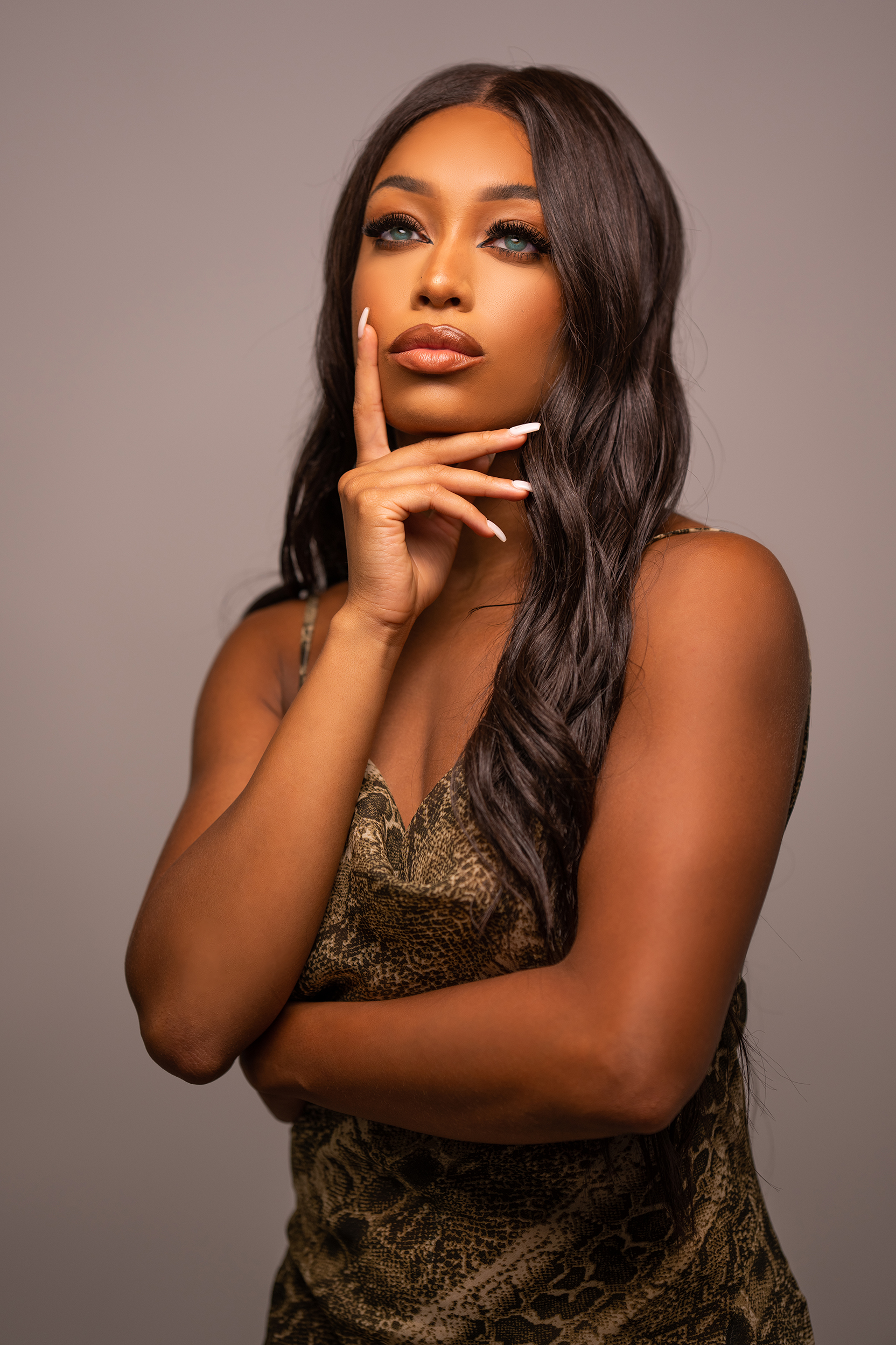 Portrait shot by Manny Ortiz with subject and lighting further fromobackground Portrait shot with subject and lighting further fromobackground