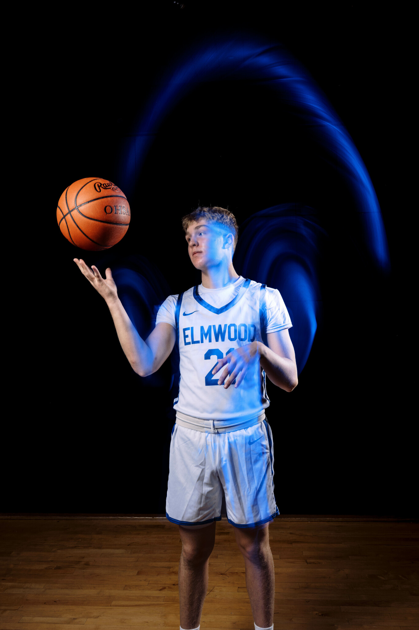 Light trails created from motion Basketball player throwing a ball causing light trails to appear