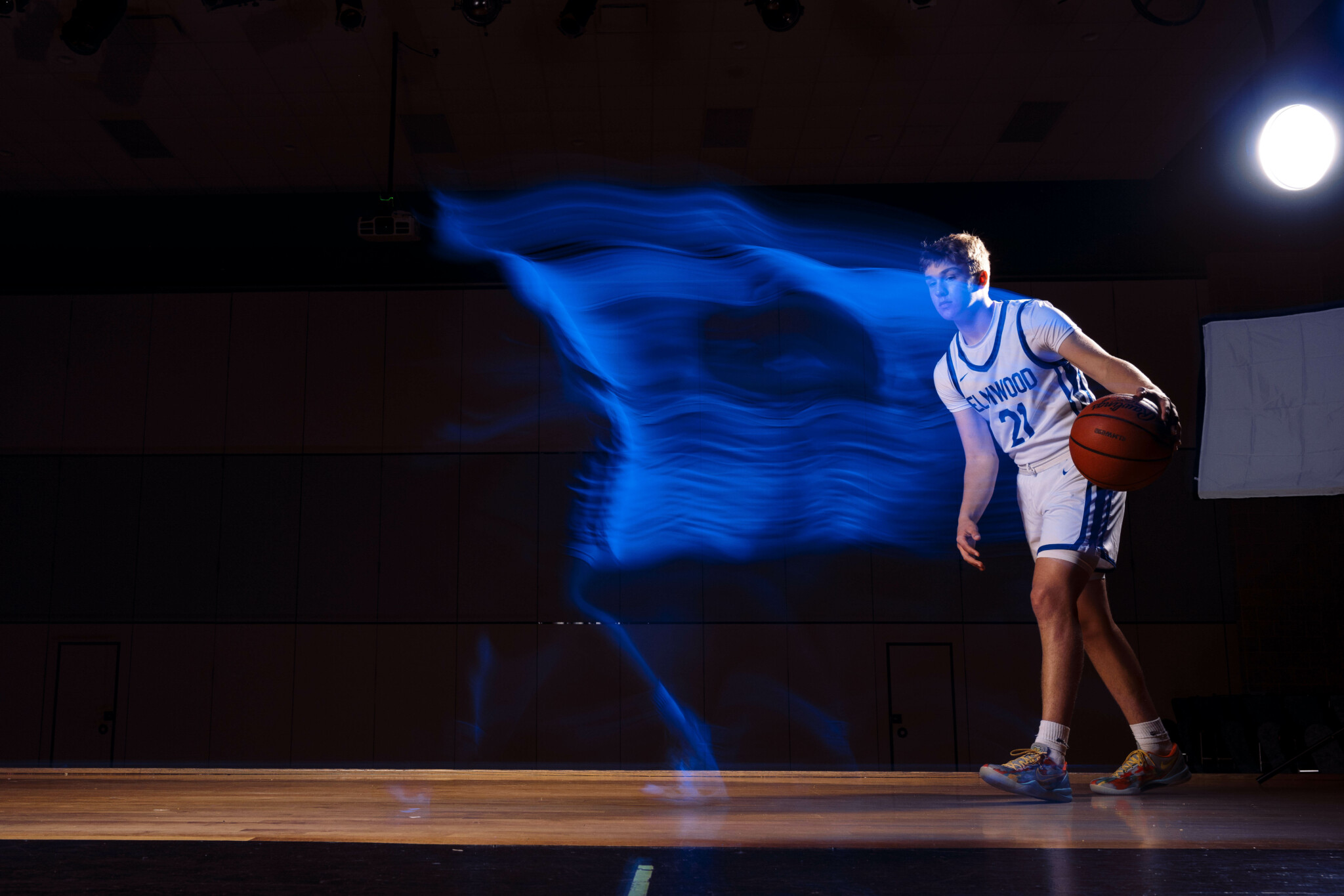Flash Set to Rear Curtain Sync Basketball player walking with light trails blocking him