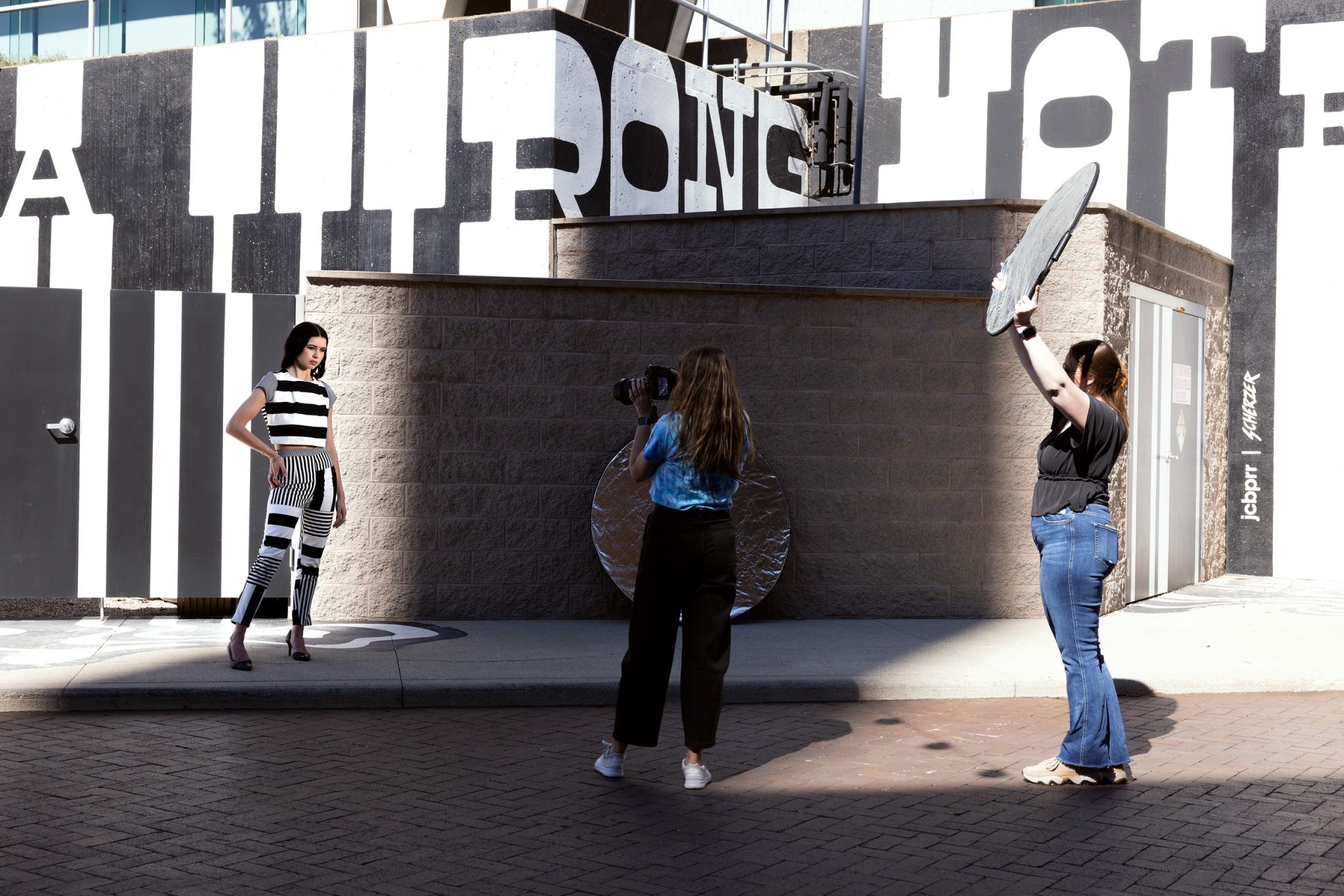 Behind the scenes look at the silver reflector bouncing sunlight back onto the subject.