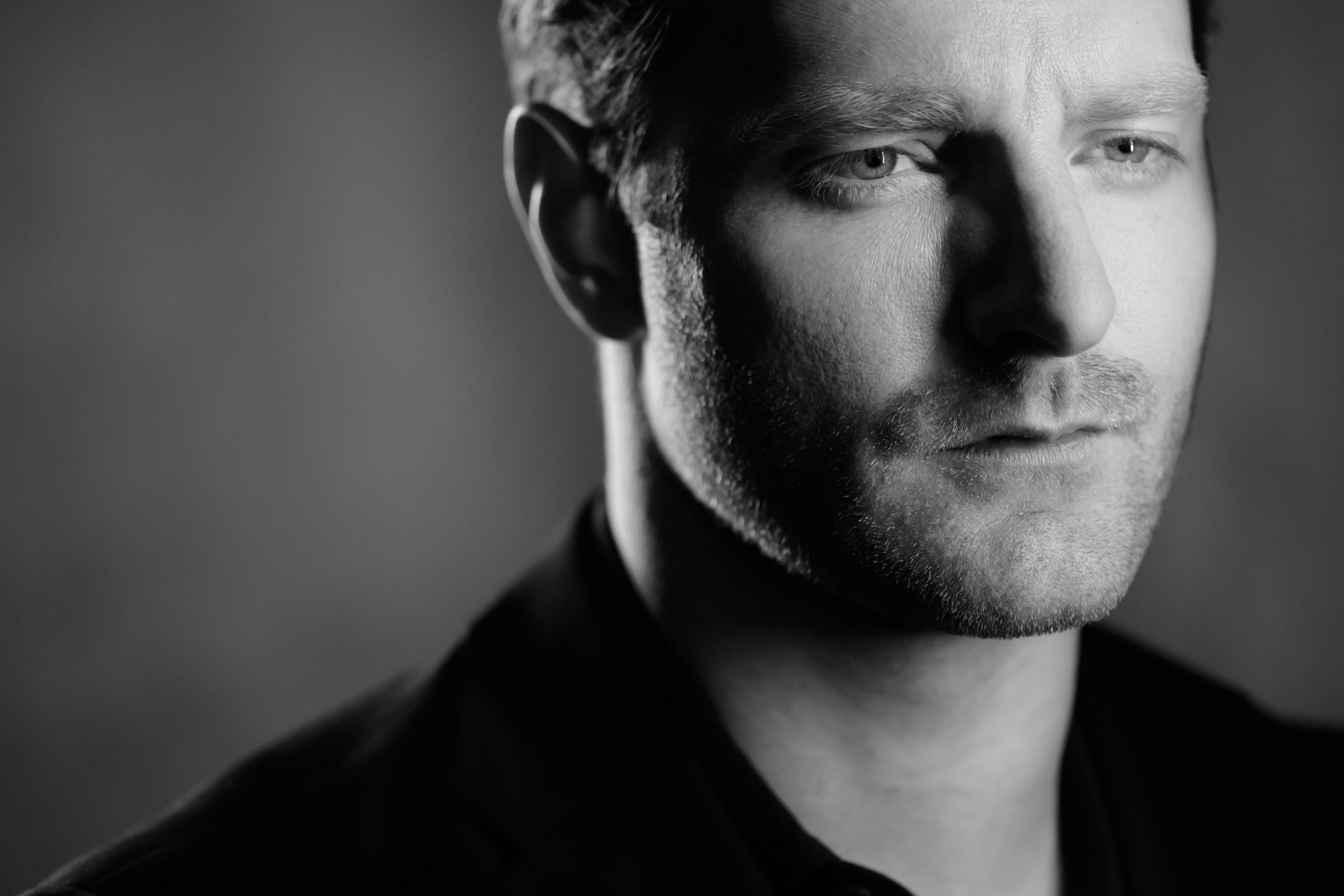 Studio Portrait with Negative Space Behind the Subject to Create Mood and Depth Studio Portrait with Negative Space Behind the Subject to Create Mood and Depth