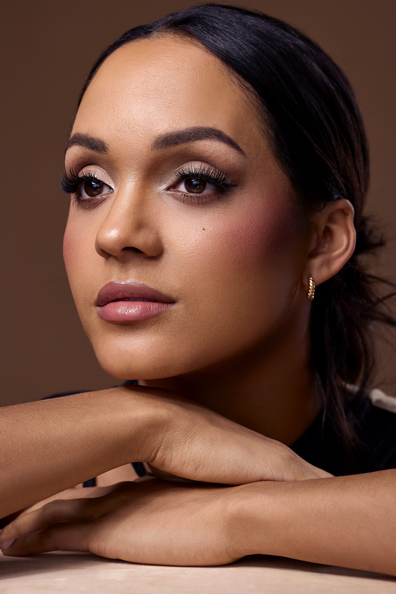 Closeup portrait blending soft wall bounced light with controlled beauty dish highlights.