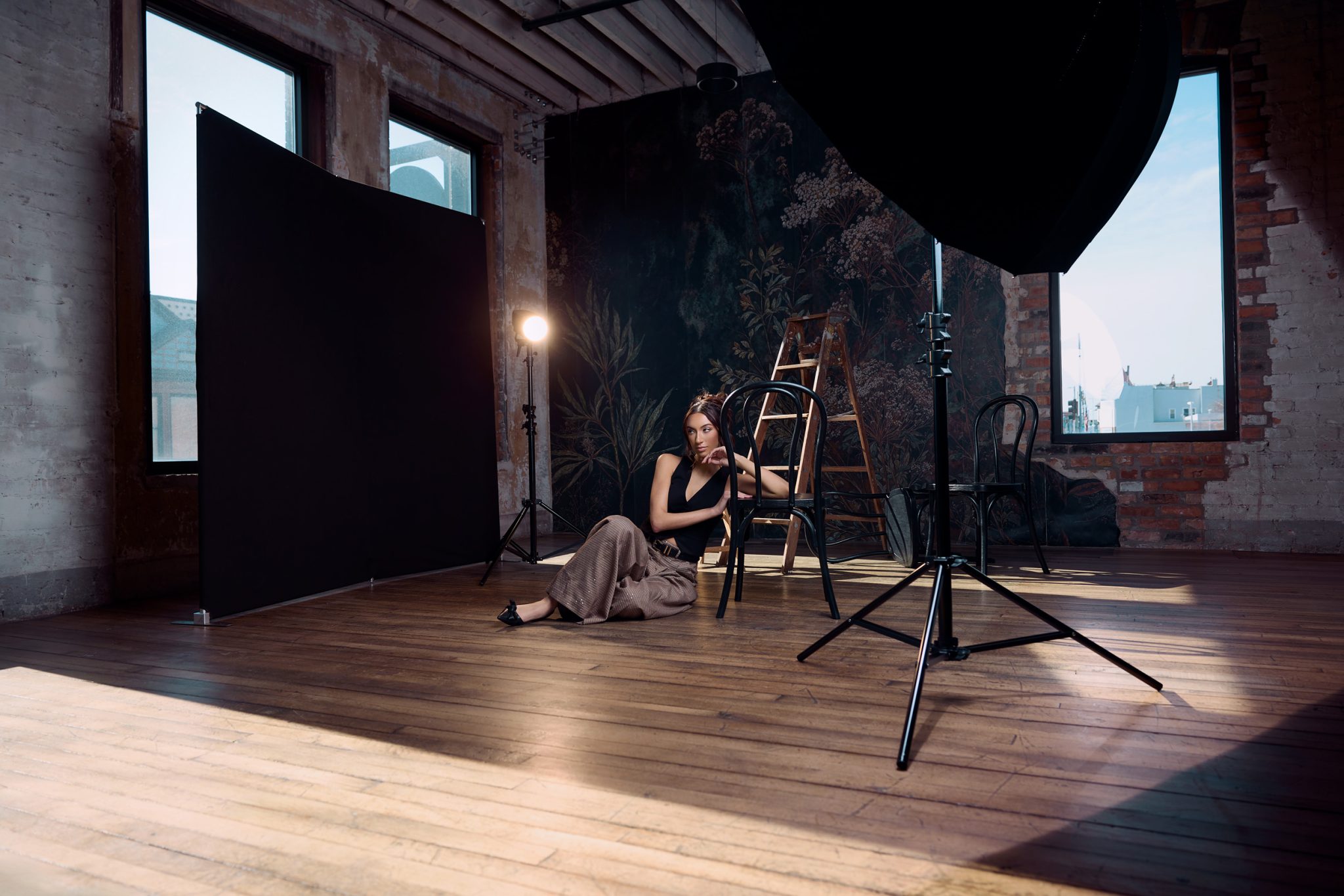Behind the scenes shows the black V-Flat blocking harsh window light while strobes shape the scene.