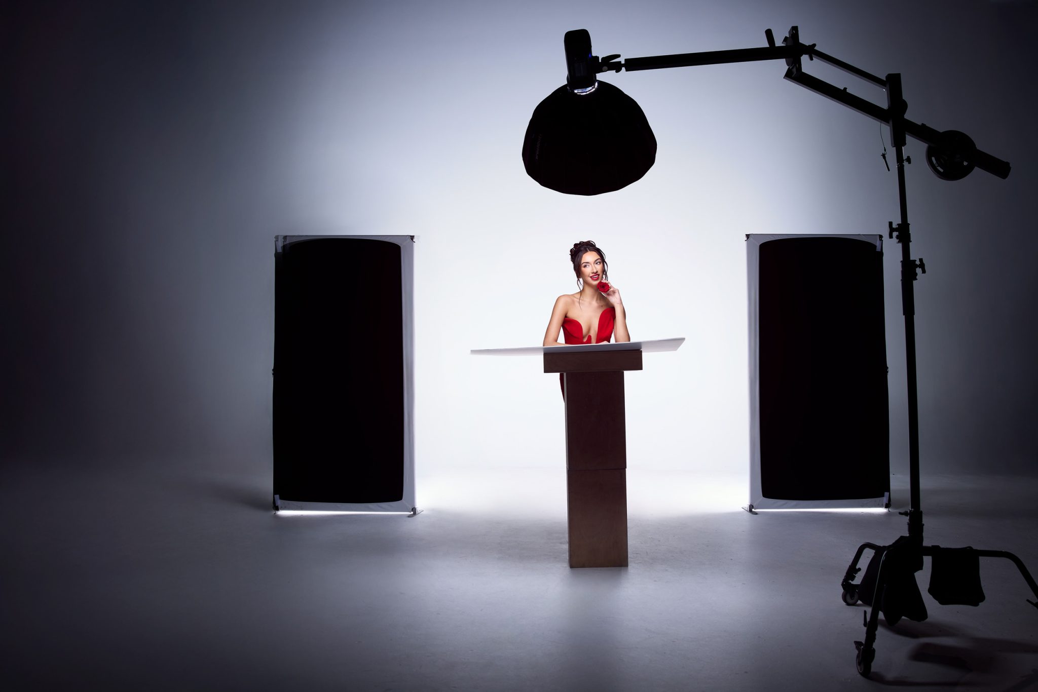 Behind the scenes shows strobes bounced into the V-Flat for soft even background lighting.