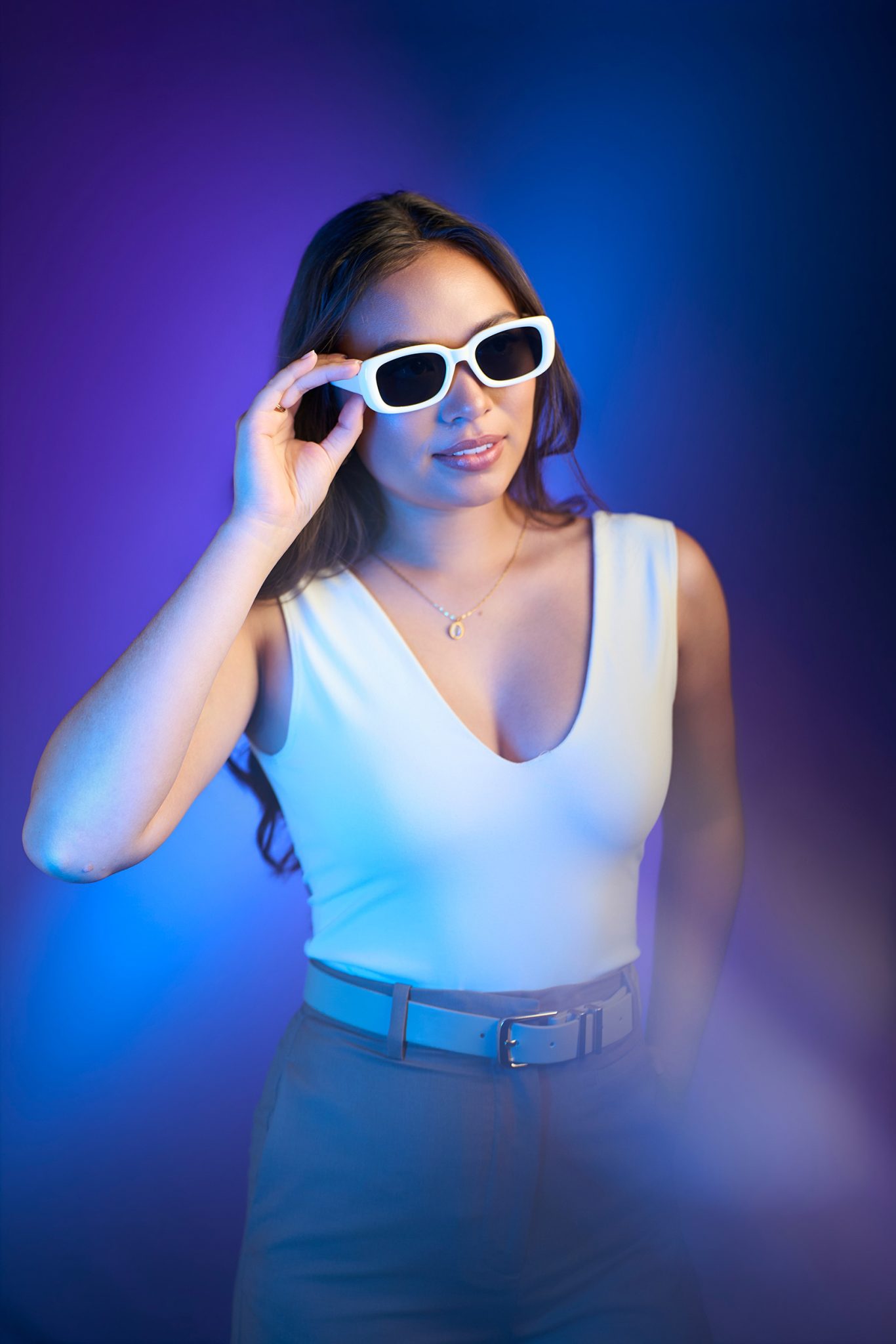 Cool-toned RGB lighting adds teal and purple color for a bold creative portrait.