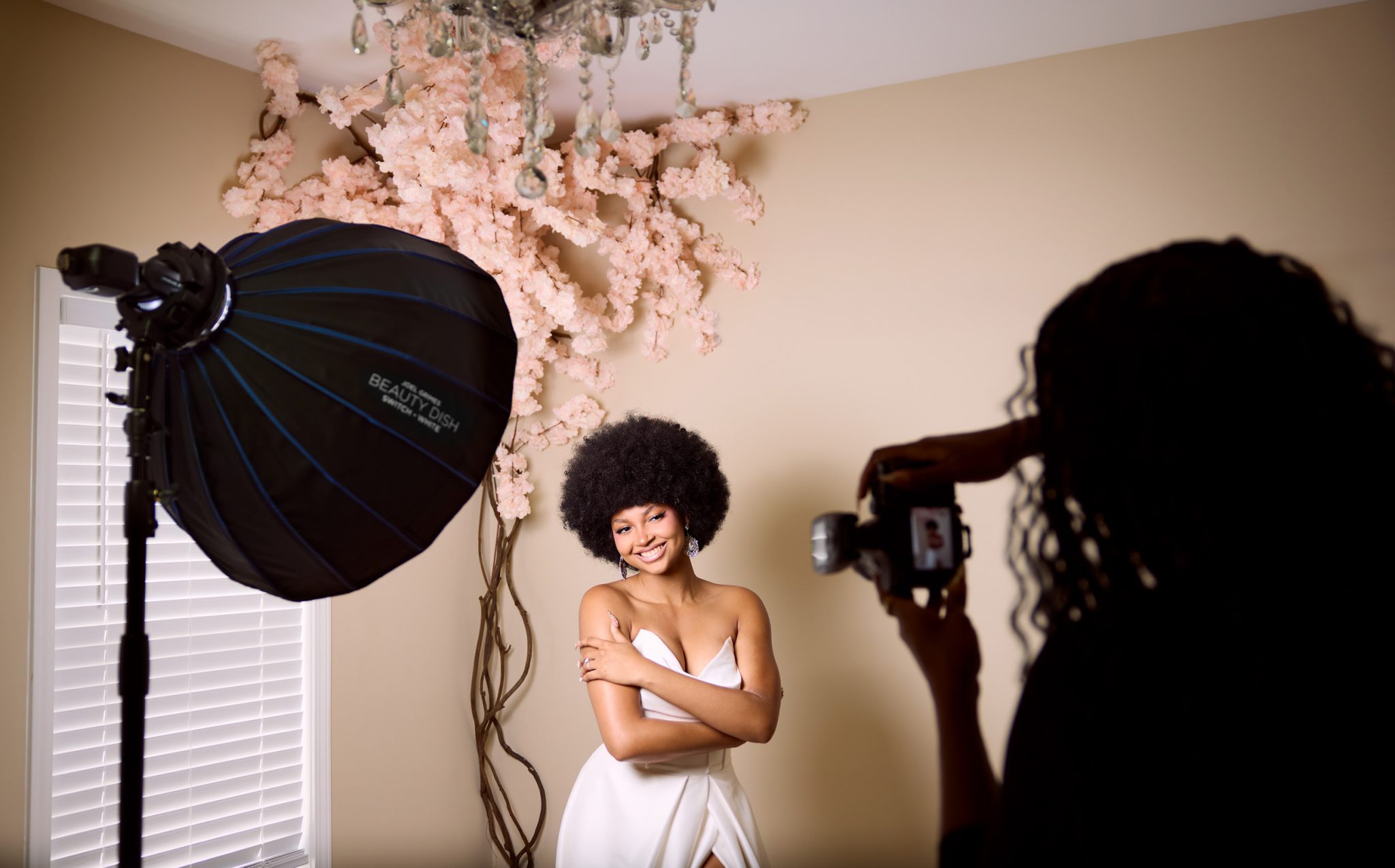 Behind the scenes with the FJ100 Speedlight and beauty dish feathered across the bride for directional light.