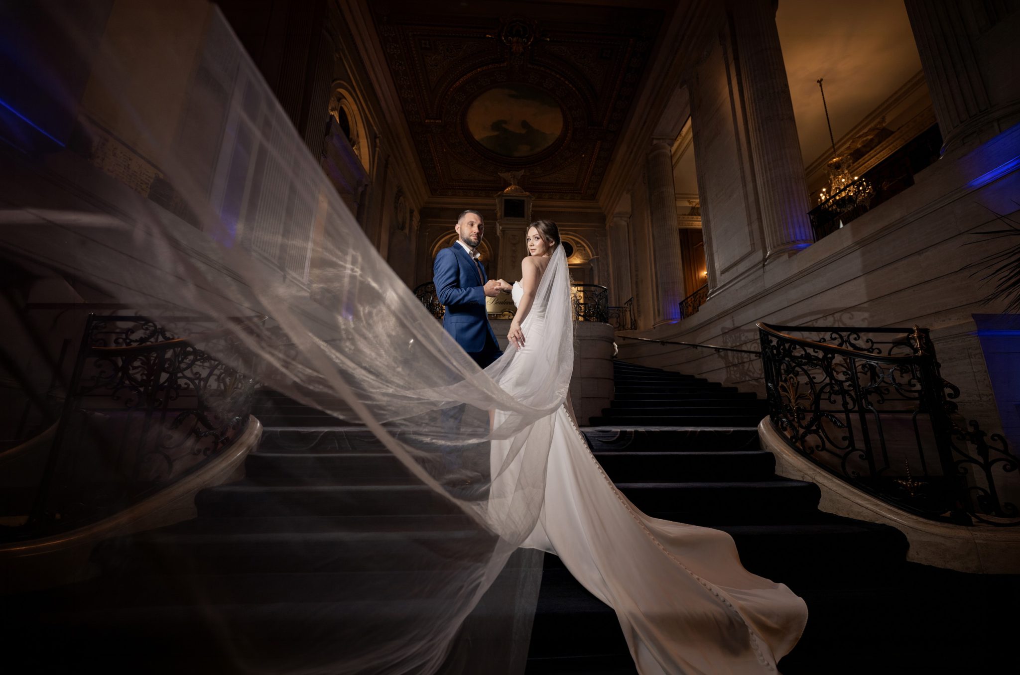 Multi-light setup adds rim light and separation while highlighting the grand staircase.