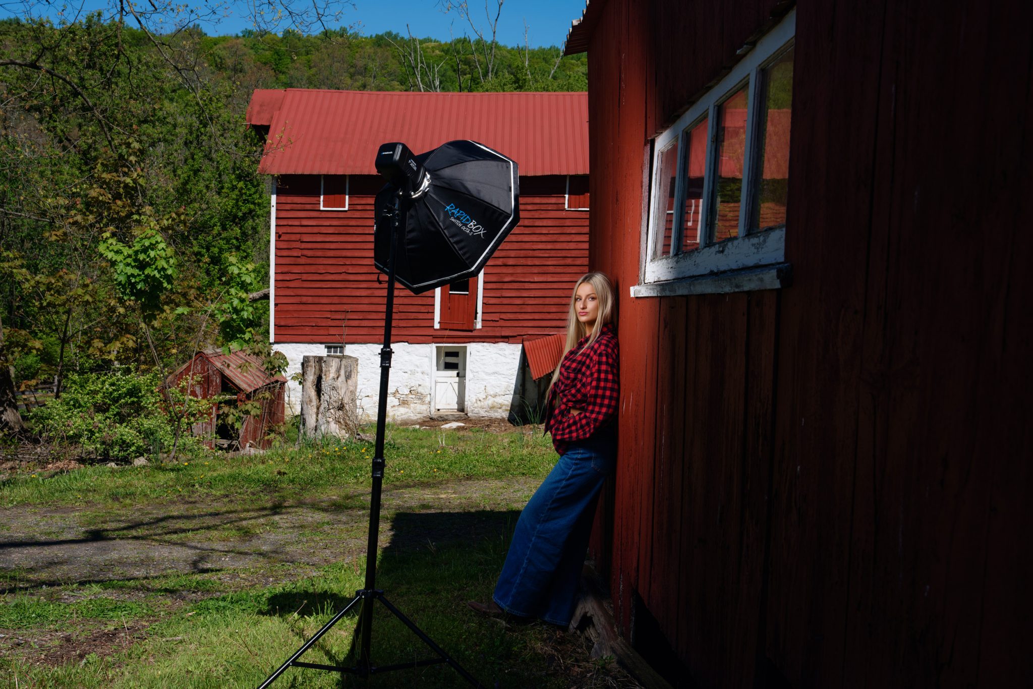 Behind the scenes with the FJ250 and Rapid Box Switch Octa lighting the subject against the barn wall.