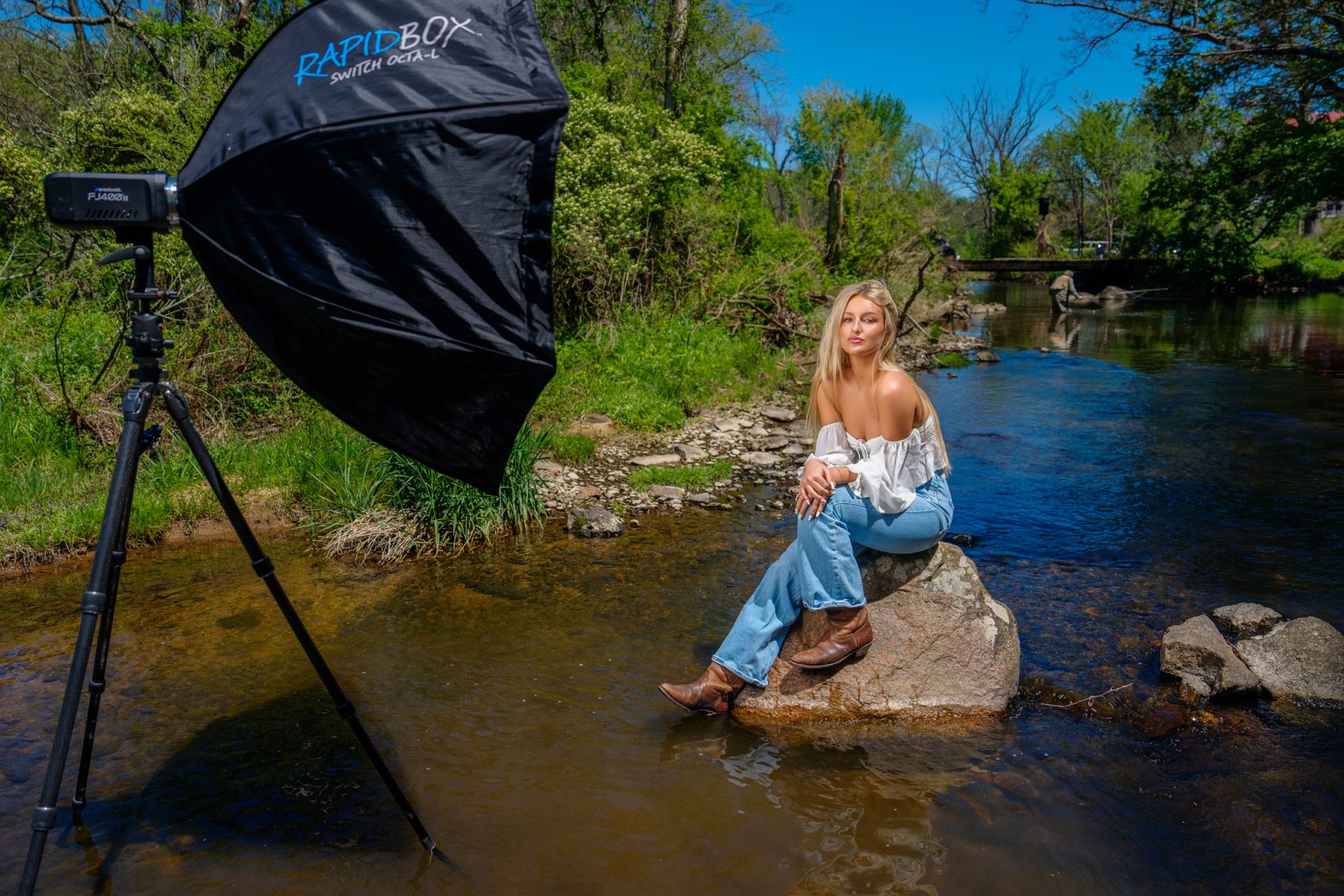 Behind the scenes with the FJ400 II and softbox setup beside Liv in the river.