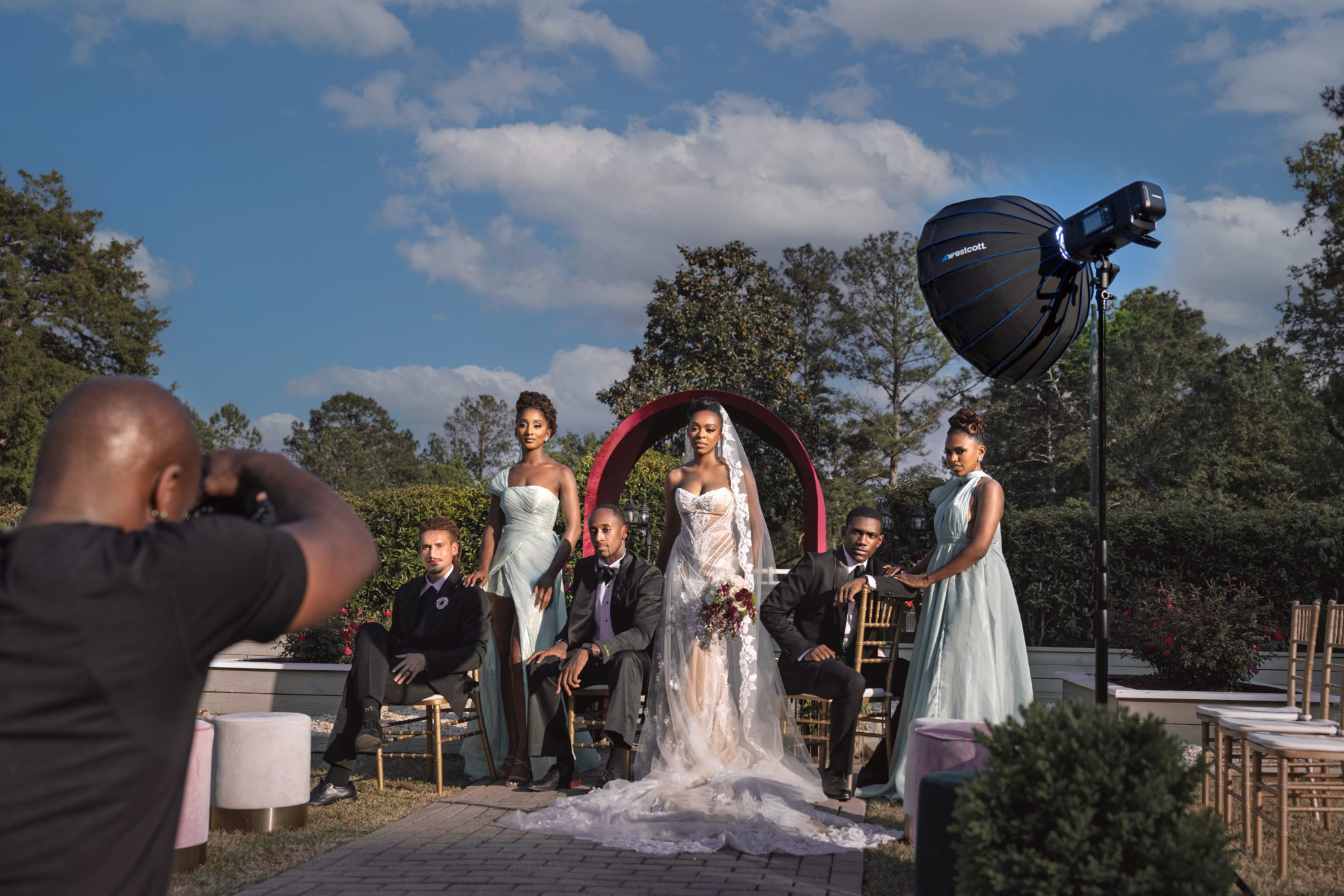 Behind the scenes showing the Westcott FJ800 strobe used to overpower harsh sunlight and control the scene.