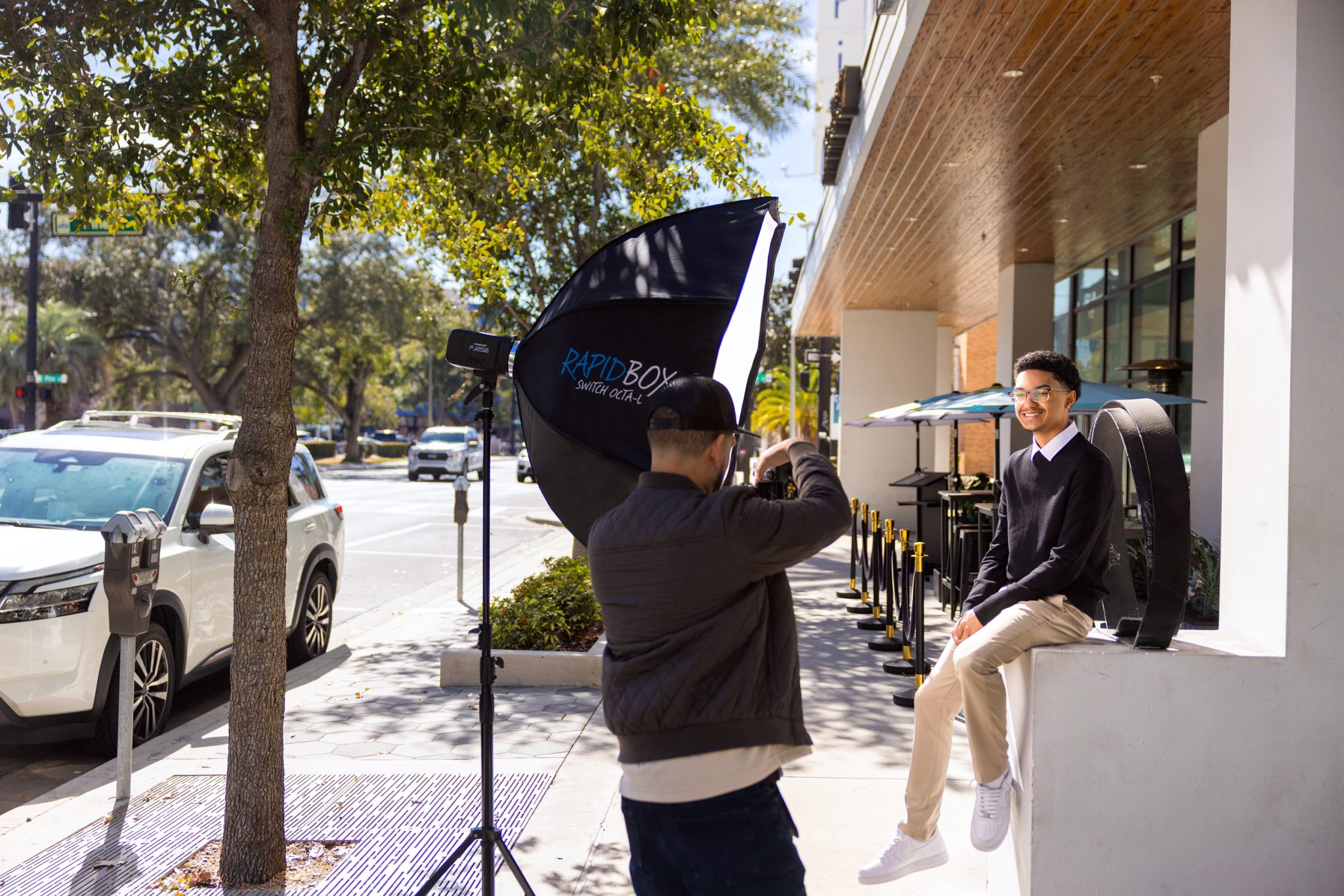 Behind the scenes of setup shows a large modifier lighting a full body setup.