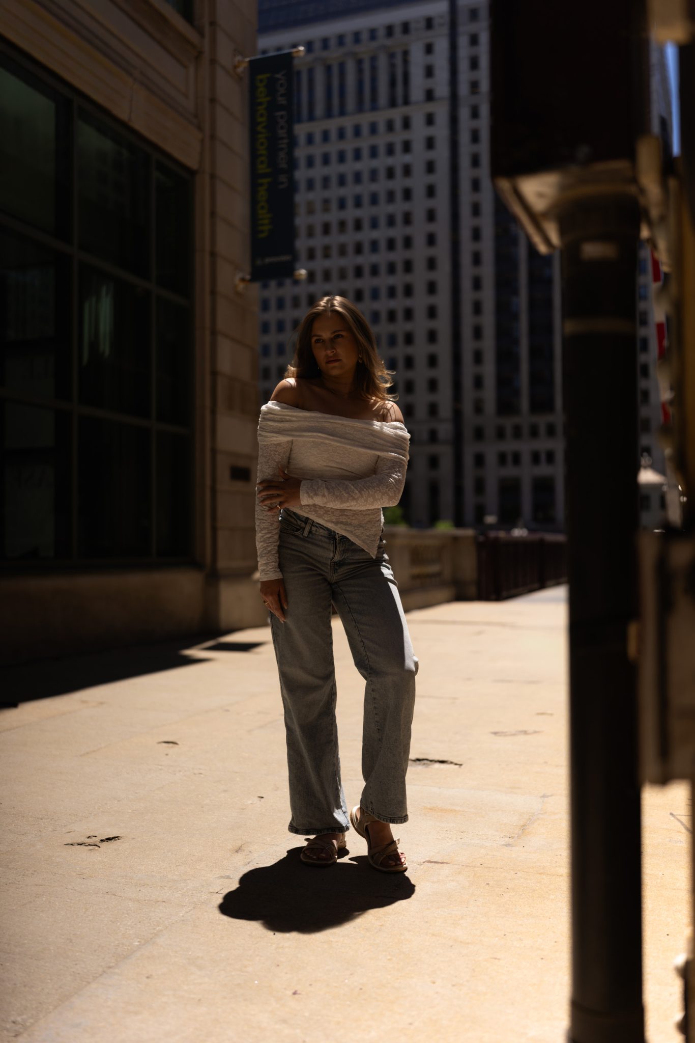 Natural light portrait leaves the subject darker against the harsh midday sun.