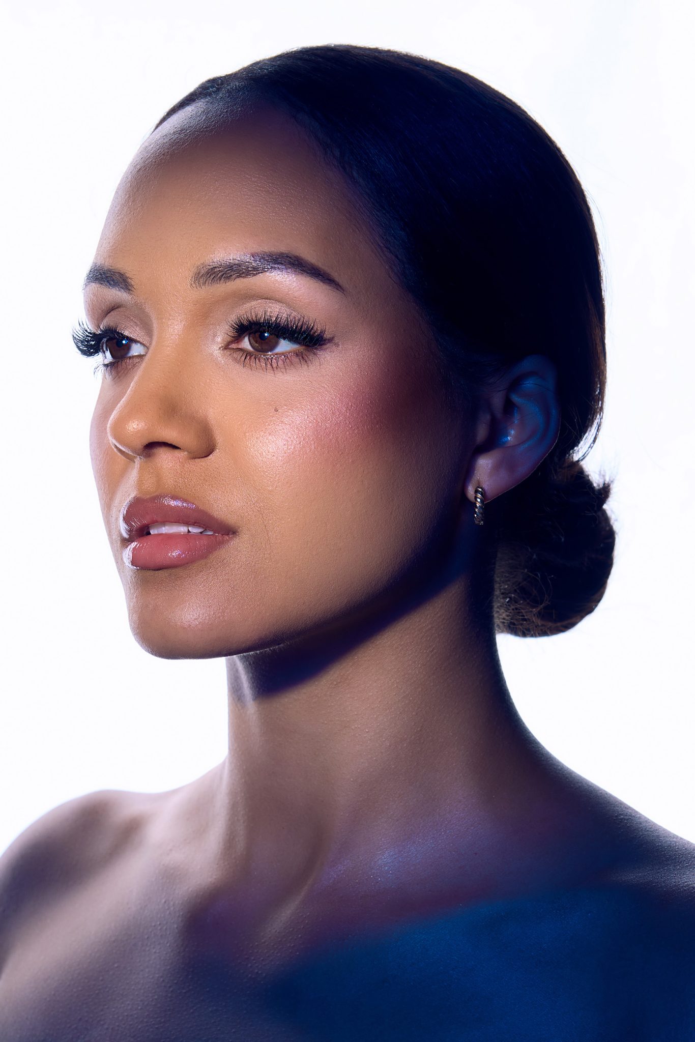 Full dramatic setup with back light, Optical Spot, and 53-inch Deep Umbrella with blue gel for color contrast.