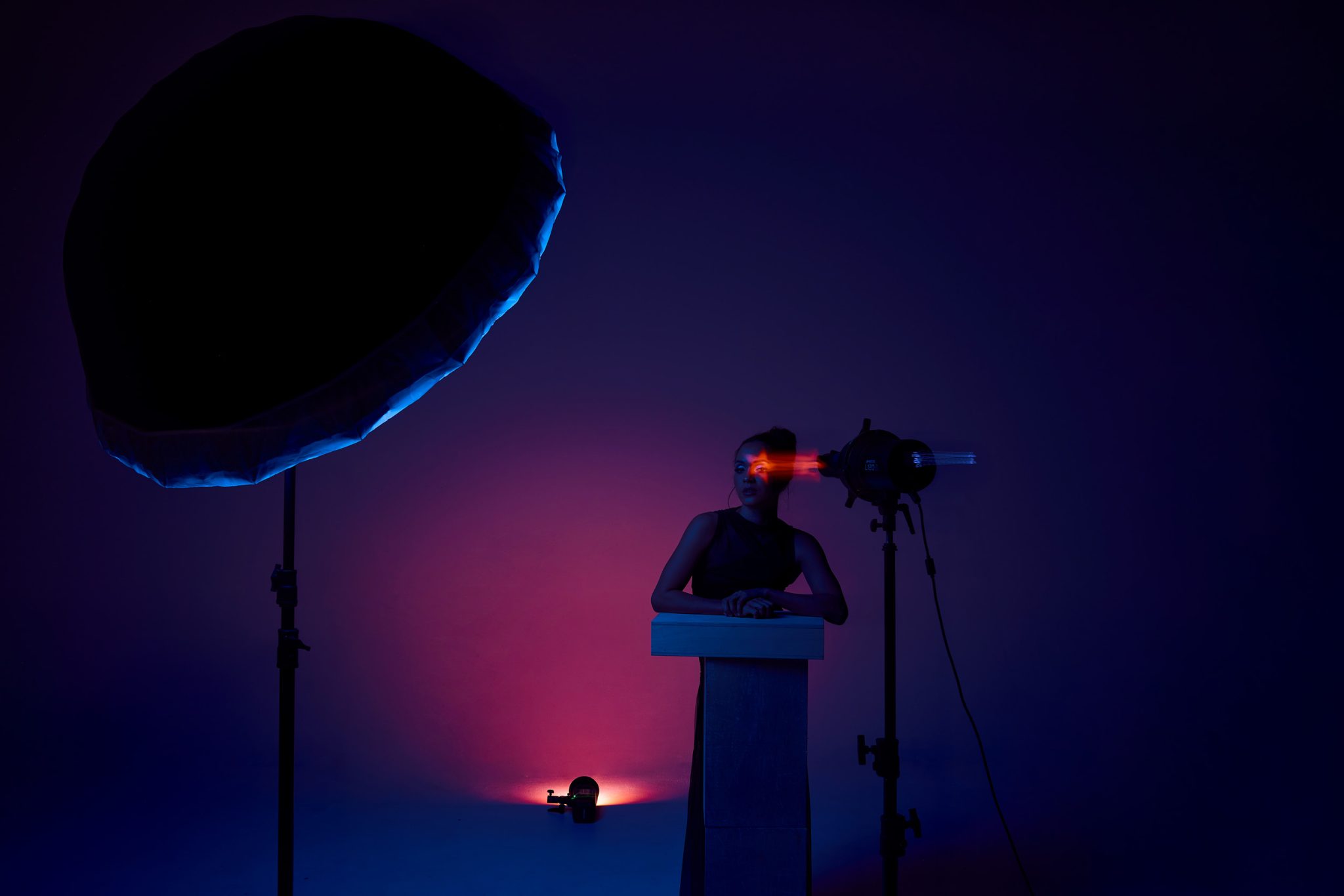 Behind the scenes showing the Optical Spot and gelled umbrella working together for bold color and shape.