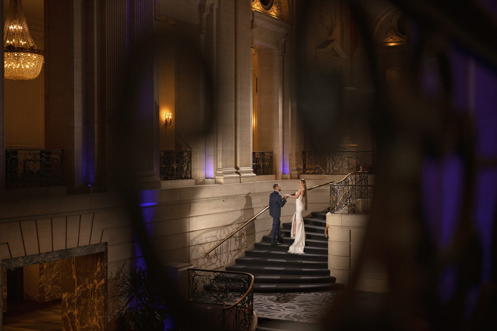 Railing in the foreground adds depth and helps frame the couple within the scene.